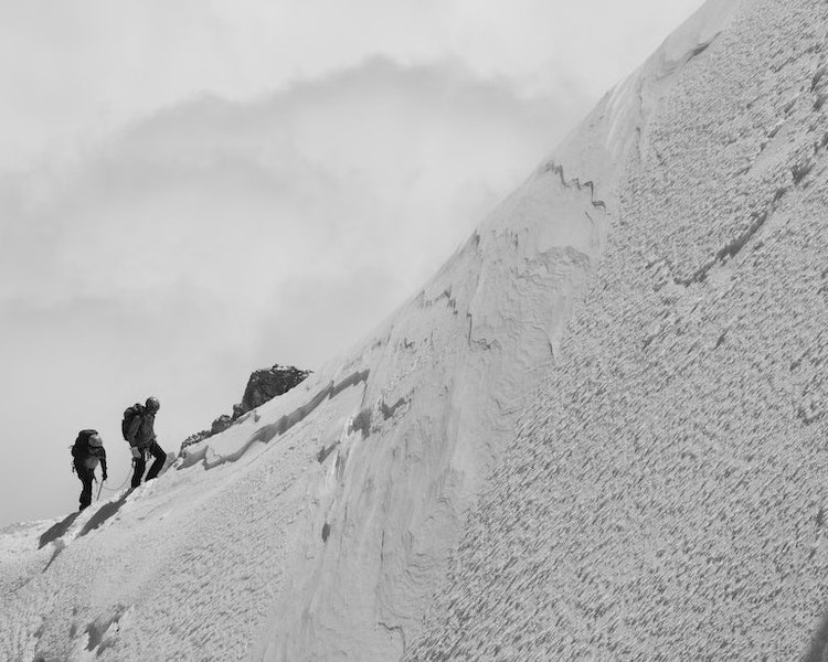 couple climbing mountain